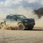 The 2026 Nissan Frontier kicking up dirt