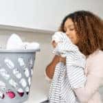 Woman smelling her clean laundry