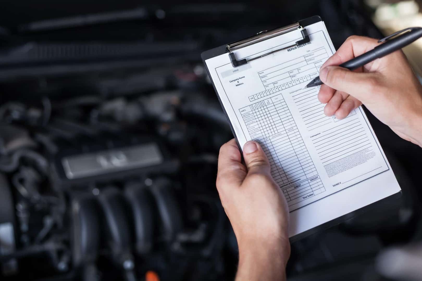 Car inspection checklist under hood of vehicle