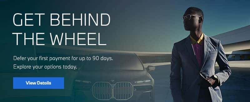Man standing in front of new BMW