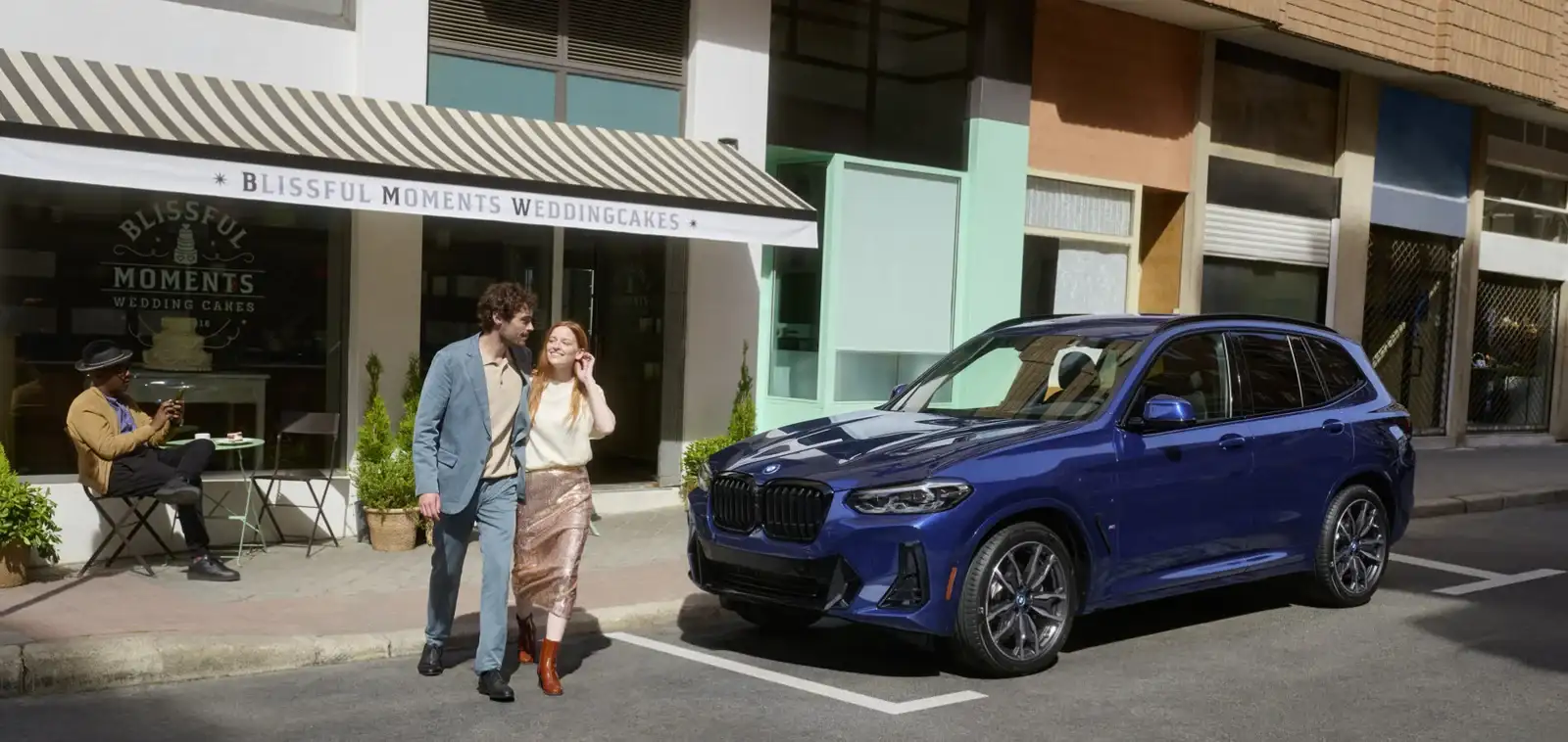 Blue BMW X3 parked on a city street