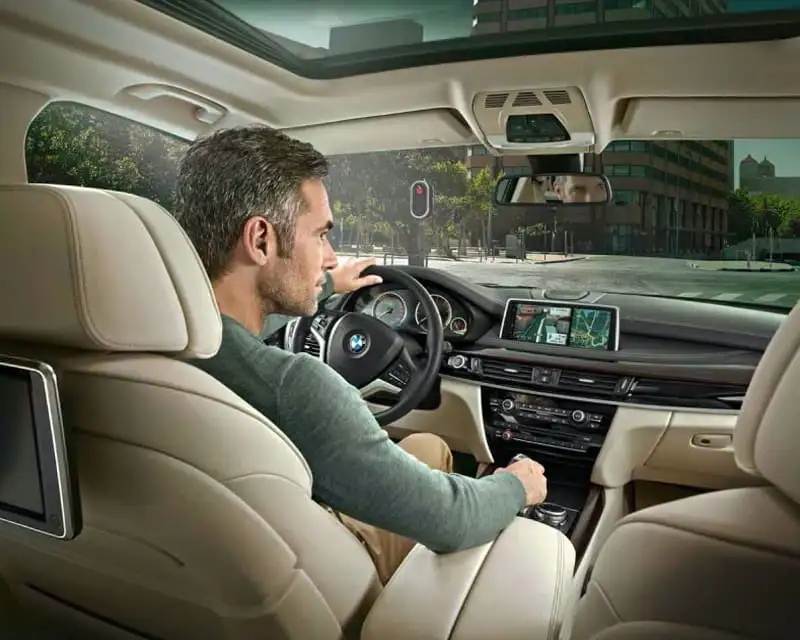 Interior of a BMW with a driver at the wheel