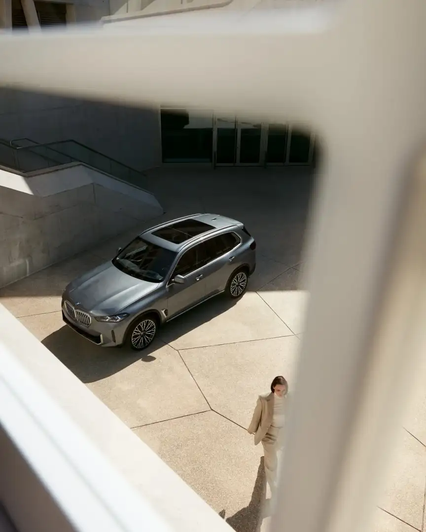 BMW X5 parked in a modern courtyard