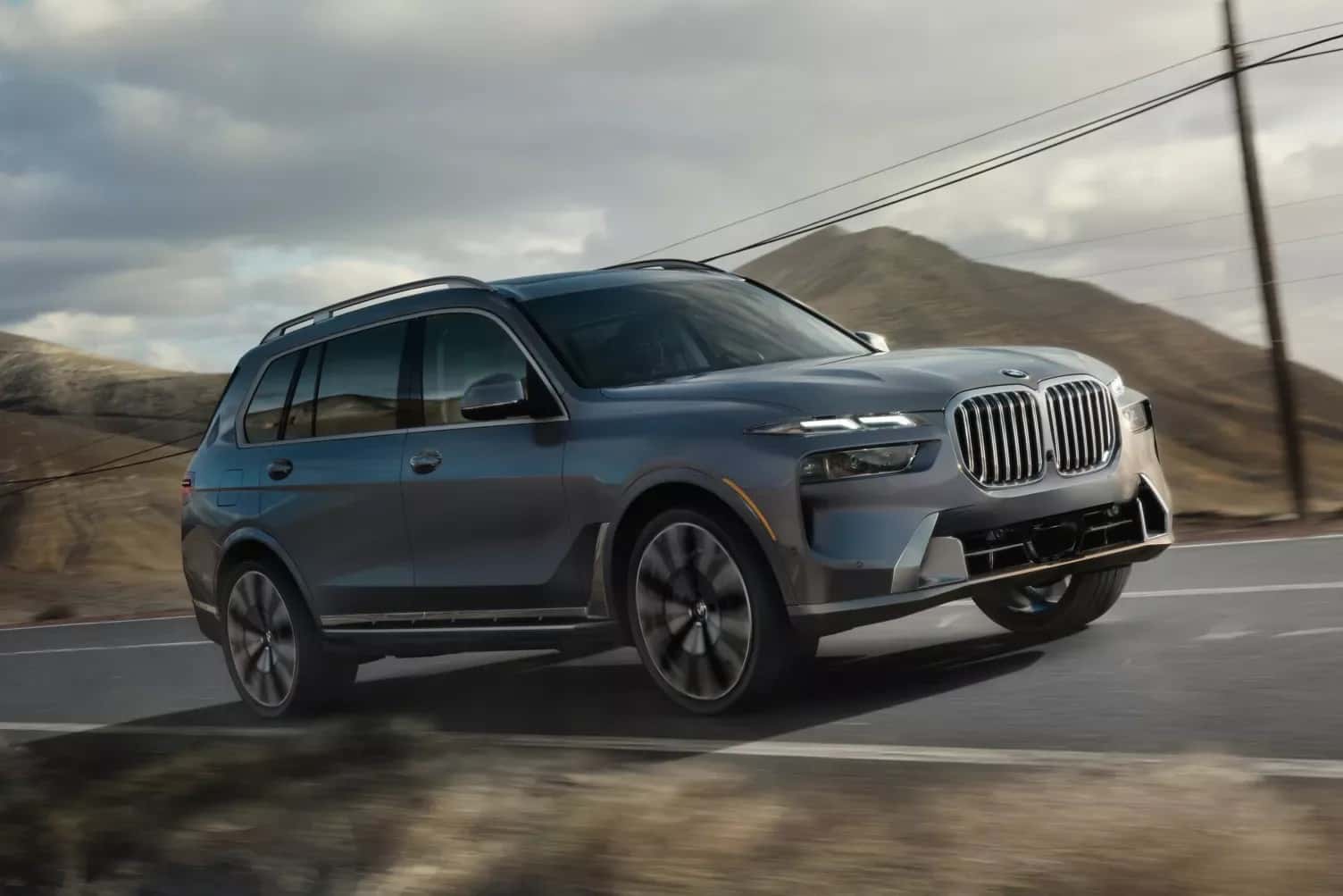 2027 BMW X7 driving on a mountain road