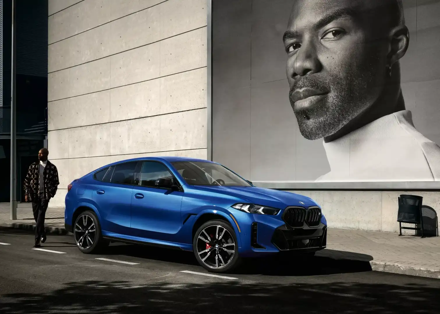 A blue BMW X6 Sports Activity Coupe in an urban setting, the new 2027 model at BMW of Fort Walton Beach