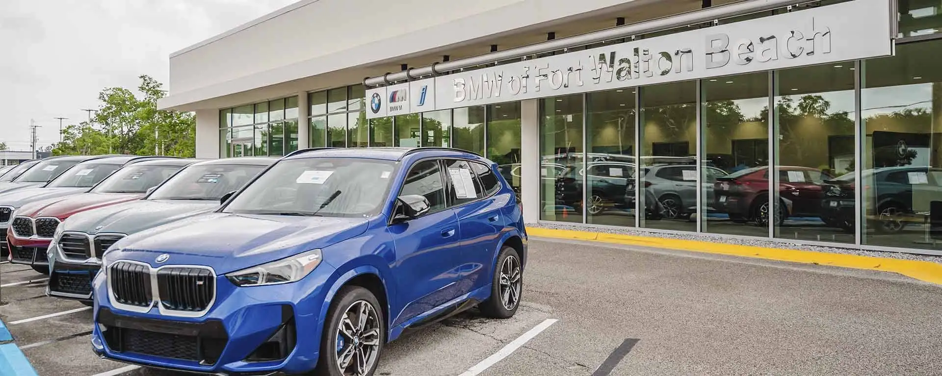 New BMWs lined up outside the BMW of Fort Walton Beach showroom on North Beal Parkway