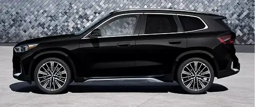 New BMW SUV driving on a road