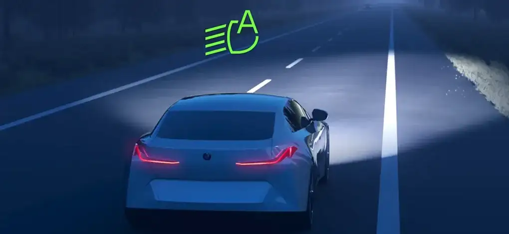 2027 BMW X1 headlights illuminating a dark road with BMW High Beam Assist