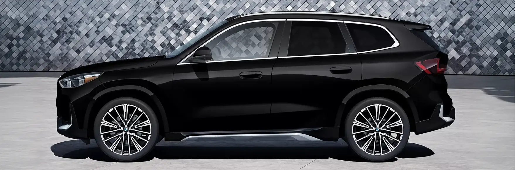 Side profile of the 2027 BMW X1 showing its bold wheel arches and raised stance
