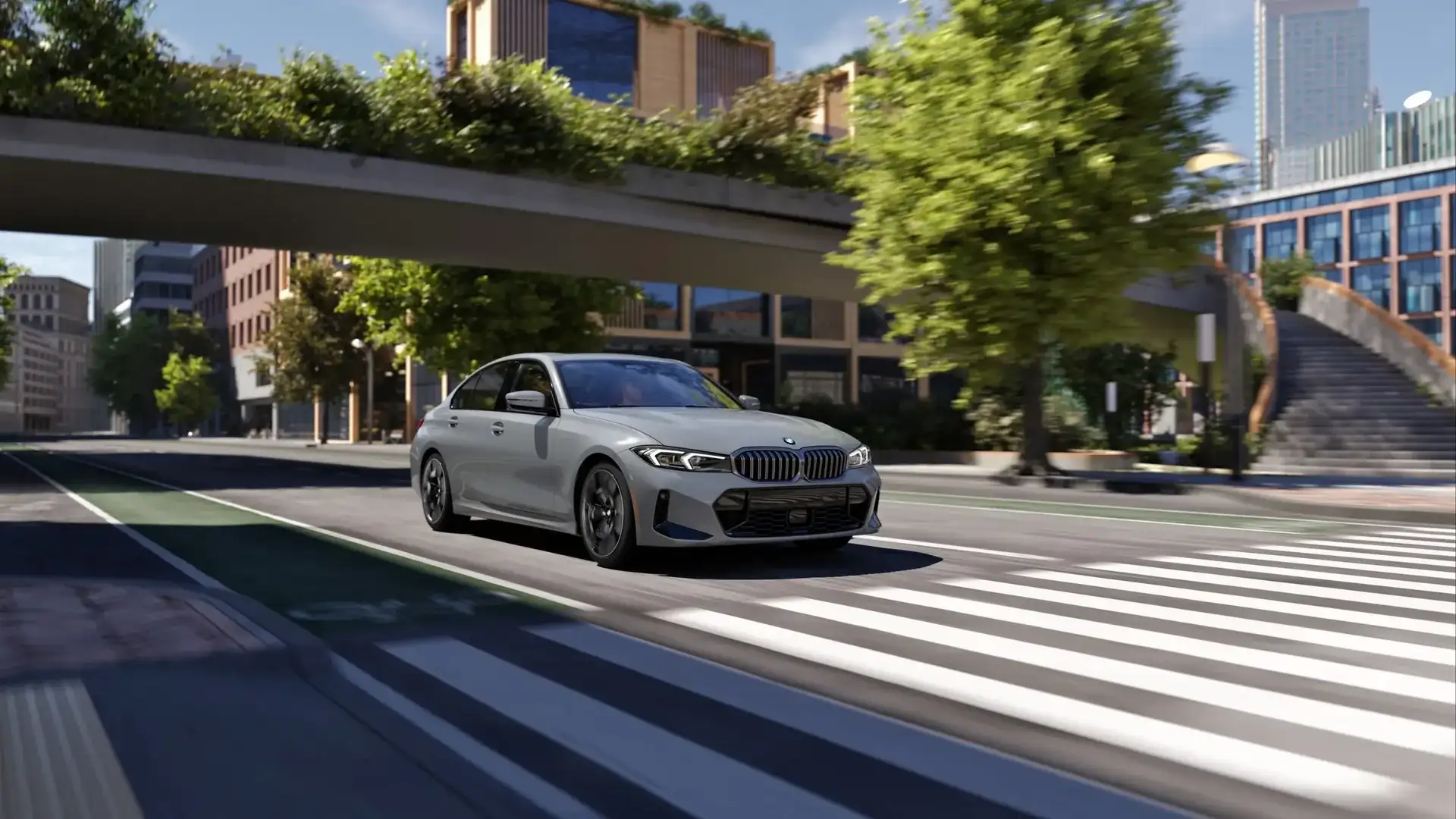 2026 BMW 3 Series sedan driving through a city intersection, the compact luxury sport sedan covered in this buyer guide from BMW of Fort Walton Beach