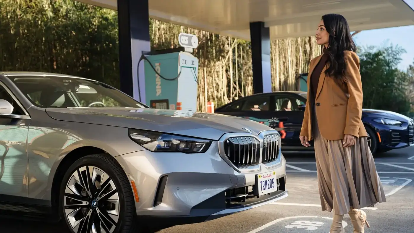 BMW 5 Series and i4 at a fast-charging station, planning EV charging before you buy on the Emerald Coast