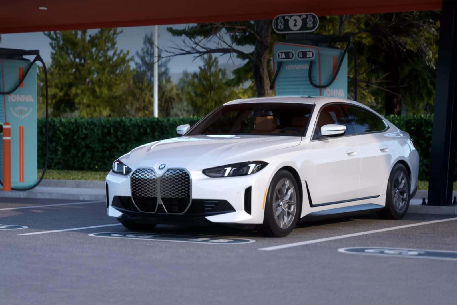 A white BMW i4 parked at an IONNA charging station