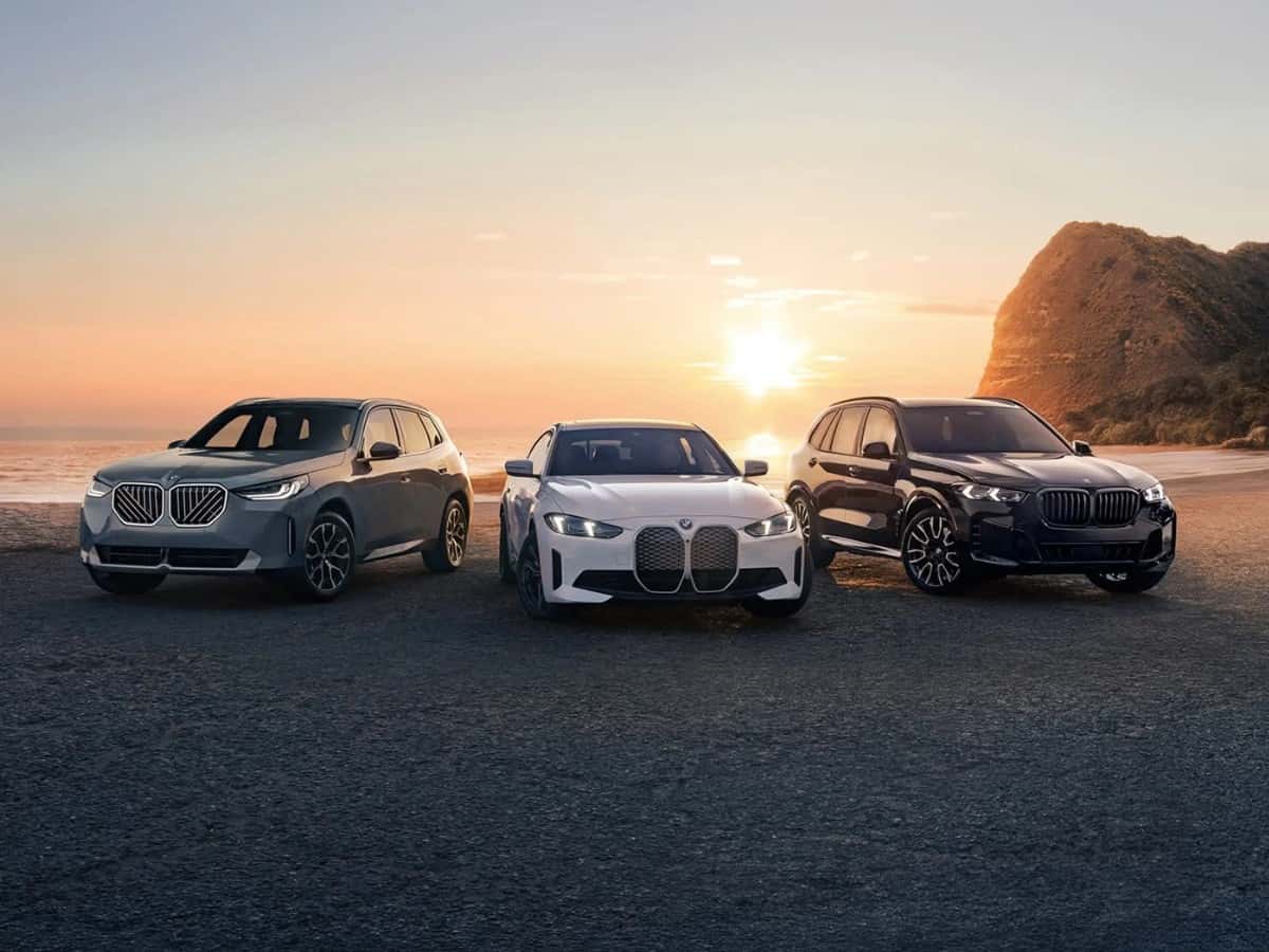 BMW X3, i4, and X5 parked on the sand at sunset on the coast, the climate BMW ownership lives in on the Emerald Coast
