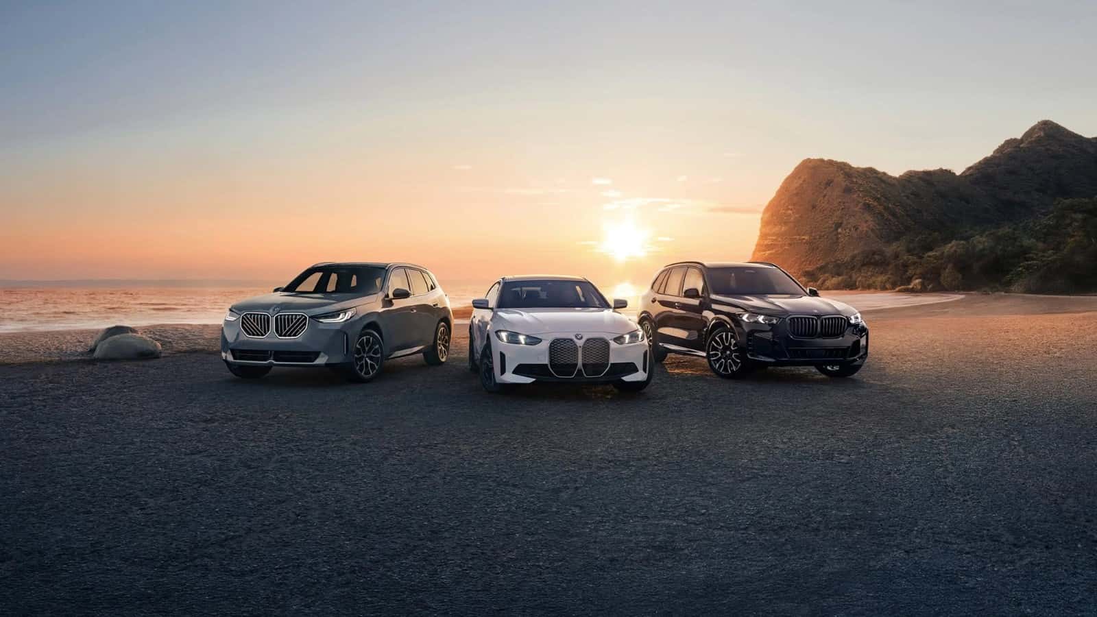 BMW X3, i4, and X5 parked on the sand at sunset, the lineup available to test drive at BMW of Fort Walton Beach on the Emerald Coast