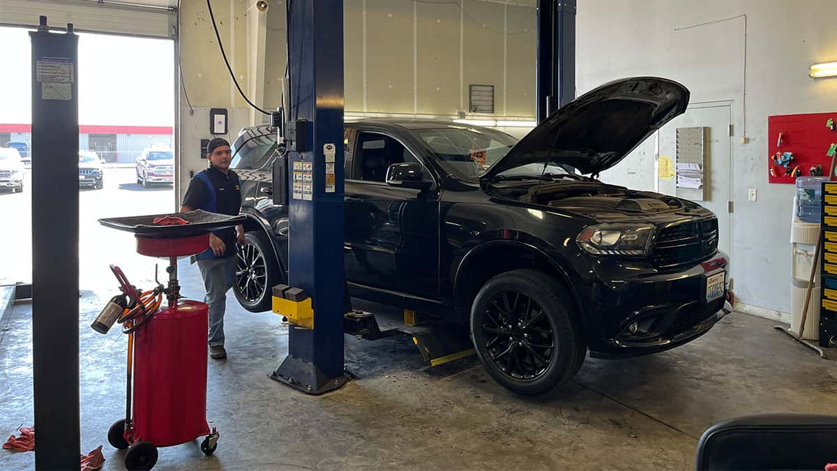 certified technician servicing a black Dodge Durango at Bud Clary Moses Lake CDJR