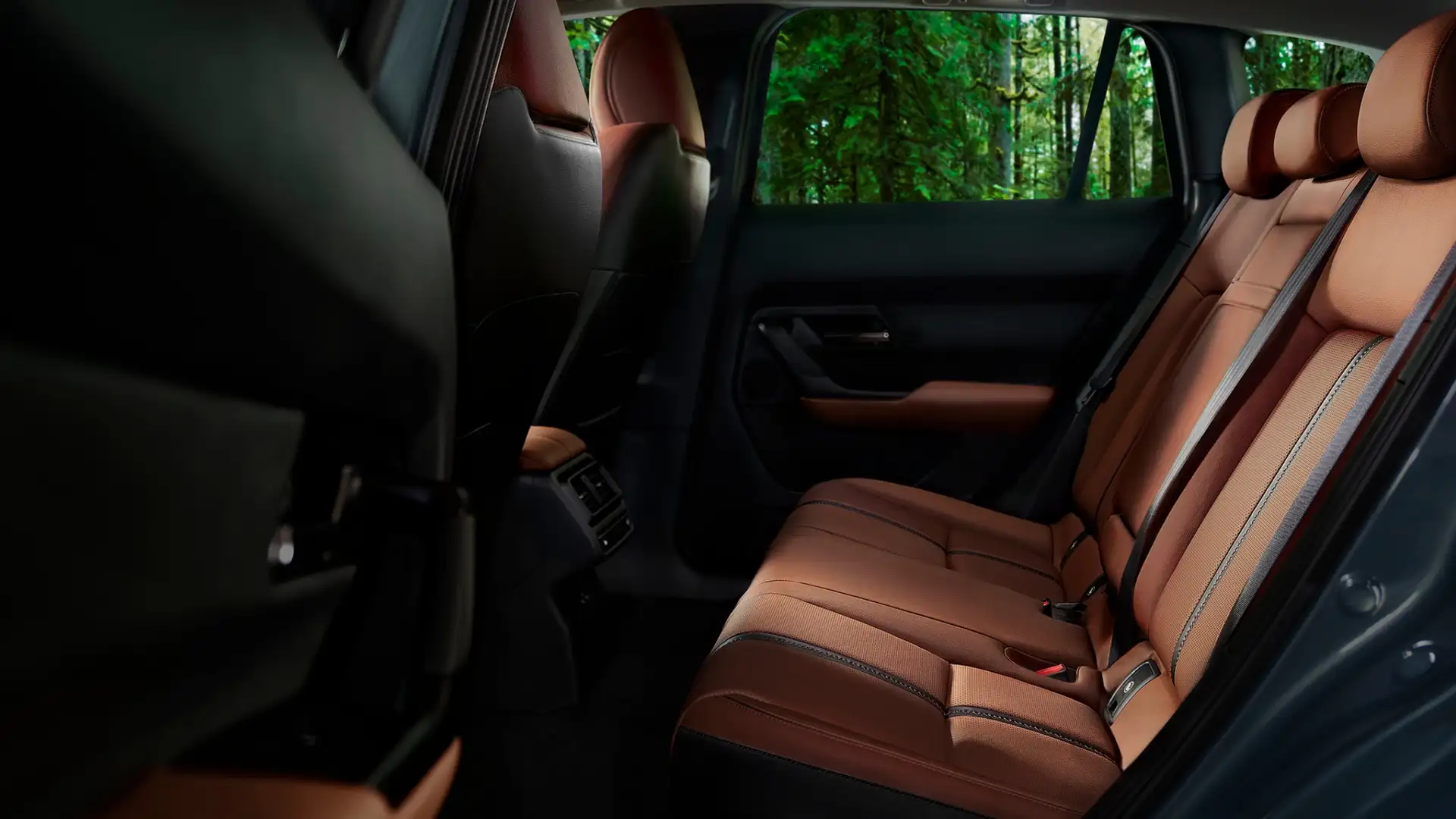2026 Mazda CX-50 rear cabin with brown leather bench seating and forest view through window