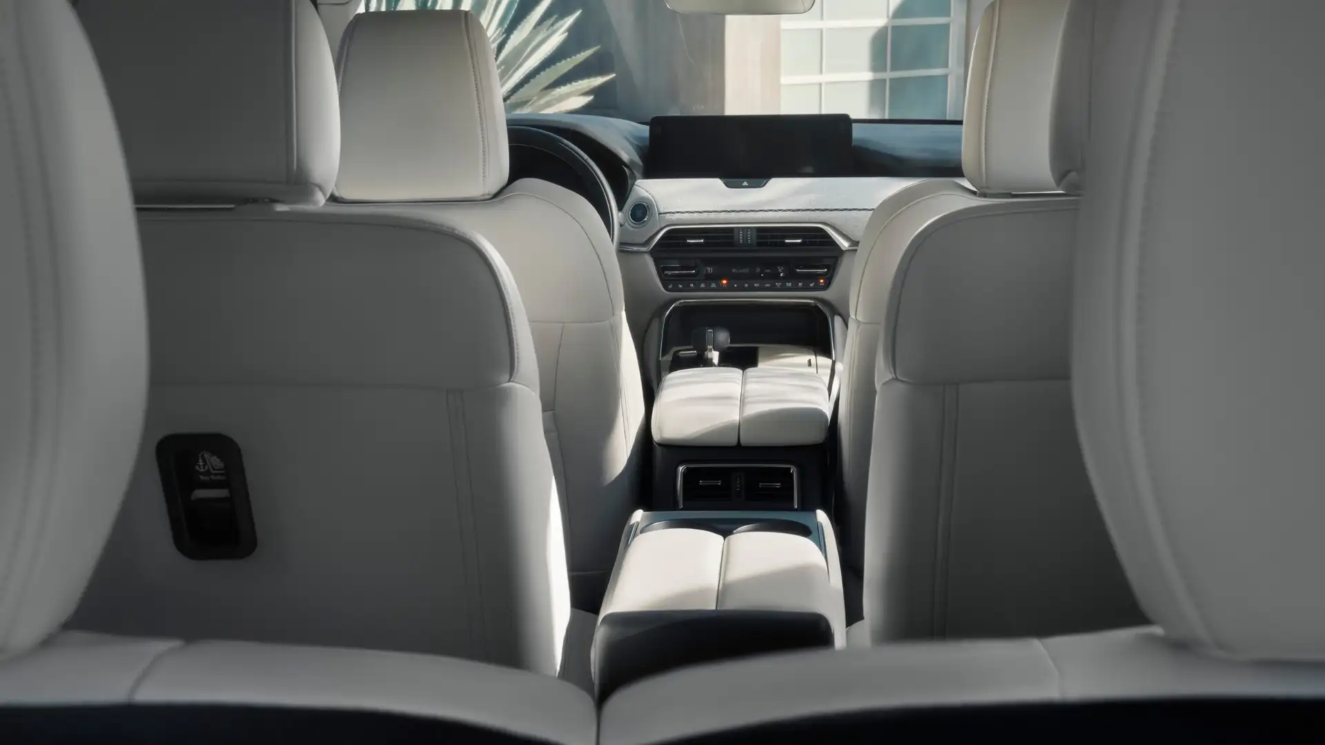 2026 Mazda CX-90 white leather cabin viewed from rear seats with center console and air vents