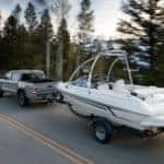 A grey 2020 Toyota Tacoma is towing a boat.