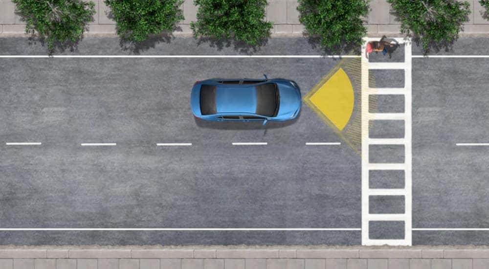 A diagram shows a blue car using the Pre-Collision System to avoid hitting a pedestrian. 