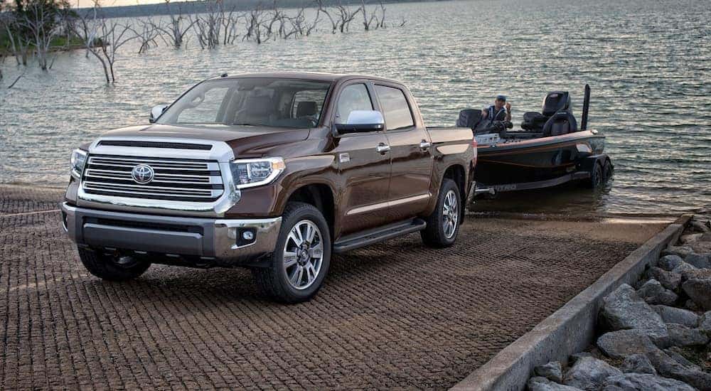 A brown 2020 Toyota Tundra is pulling a boat out of the lake after leaving a Toyota dealership near me in Indiana, PA.