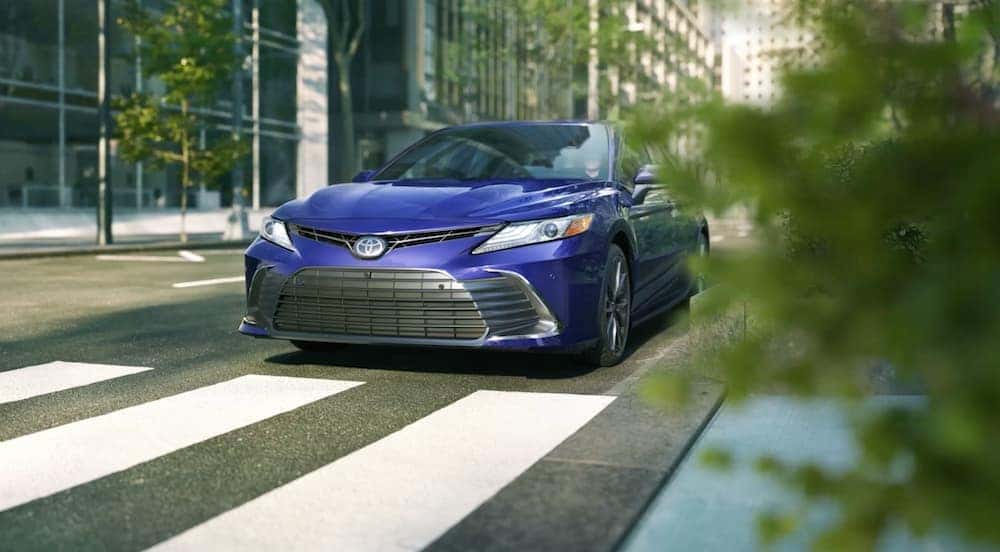 A blue 2021 Toyota Camry is at a city intersection in Indiana, PA.