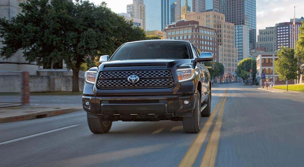A black 2021 Toyota Tundra is shown from the front driving on a street in Indiana, PA.