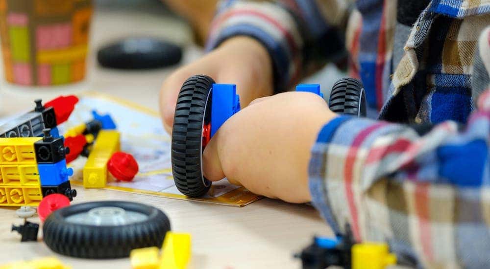A closeup shows a child playing with toys at a Pittsburgh, PA, children's museum.