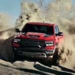 A red 2021 Ram 1500 TRX is kicking up sand while off-roading near Defiance, OH.