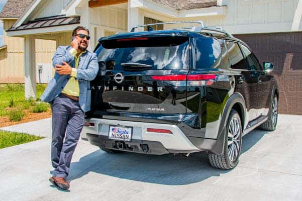 customer sitting on their new nissan rogue
