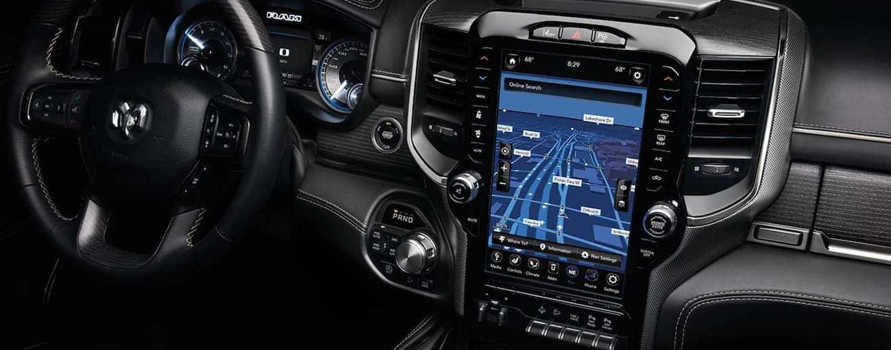 The black dashboard and infotainment screen of the 2020 Ram 1500 are shown.