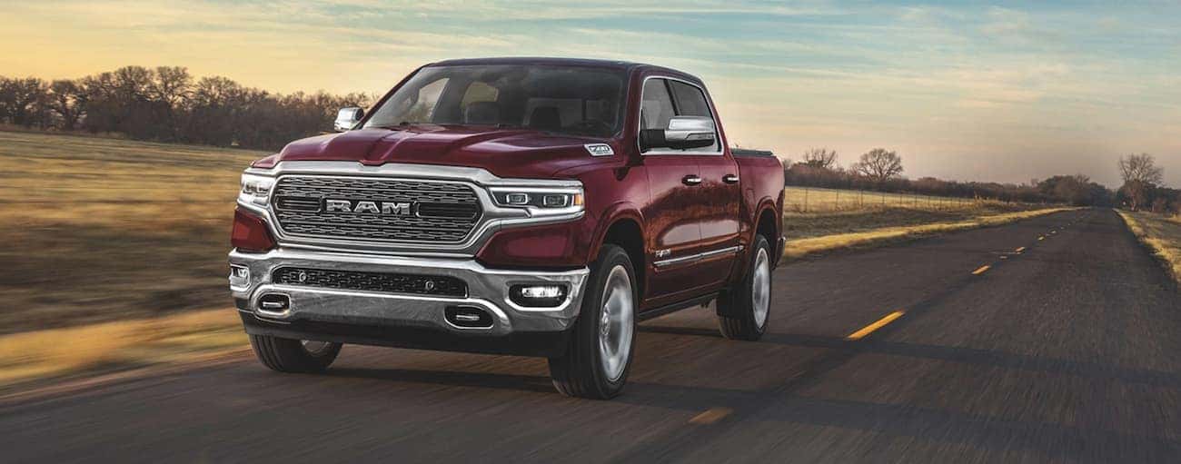 A red 2020 Ram 1500 is driving on a highway past fields near Findlay, OH.