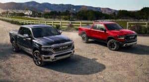 A black and a red Ram 1500 are both driving by a ranch near Florence, KY.