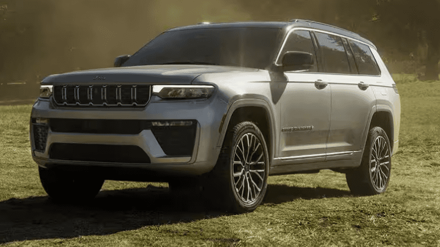 Jeep Grand Cherokee SUV parked on grassy outdoor trail