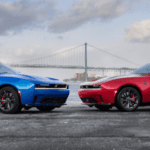 Dodge Challenger models parked near waterfront bridge