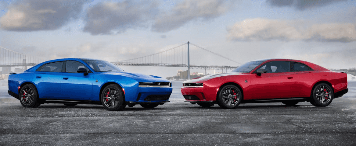 Dodge Challenger models parked near waterfront bridge
