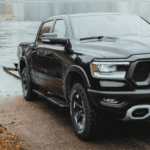 Ram pickup truck launching boat at lakeside ramp