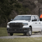 Ram 1500 towing utility trailer on gravel road