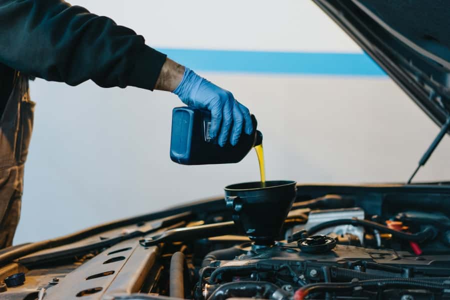 man changing oil on Volkswagen car