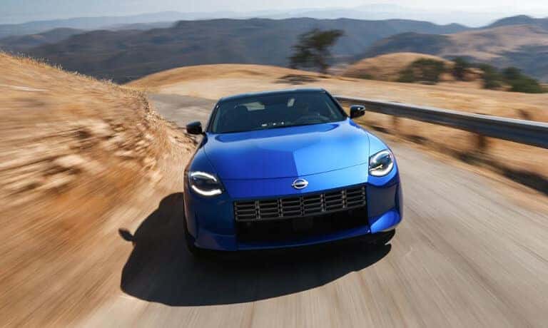 2023 Nissan Z driving head on fast down a desert road