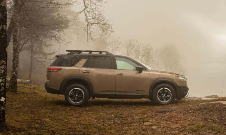 2023 Nissan Pathfinder parked in a foggy forest