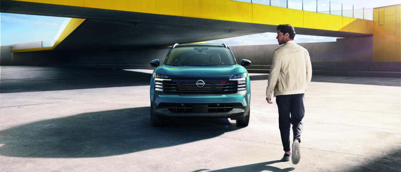 2025 Nissan Kicks Exterior Head On With Driver Approaching