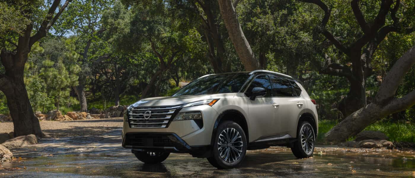 2025 Nissan Rogue Exterior Driving Through Forest
