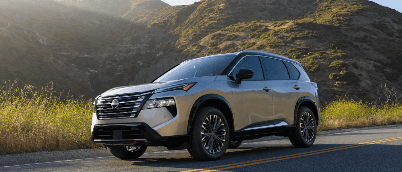 2025 Nissan Rogue Exterior Driving By Grassy Hills