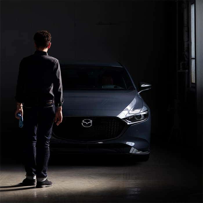Man looking at Mazda3 2.5 Turbo