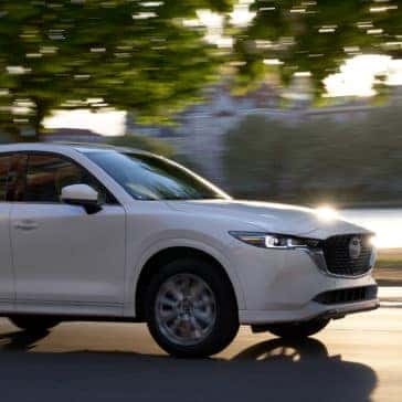 White 2022 Mazda CX-5 Compact Crossover SUV driving by river
