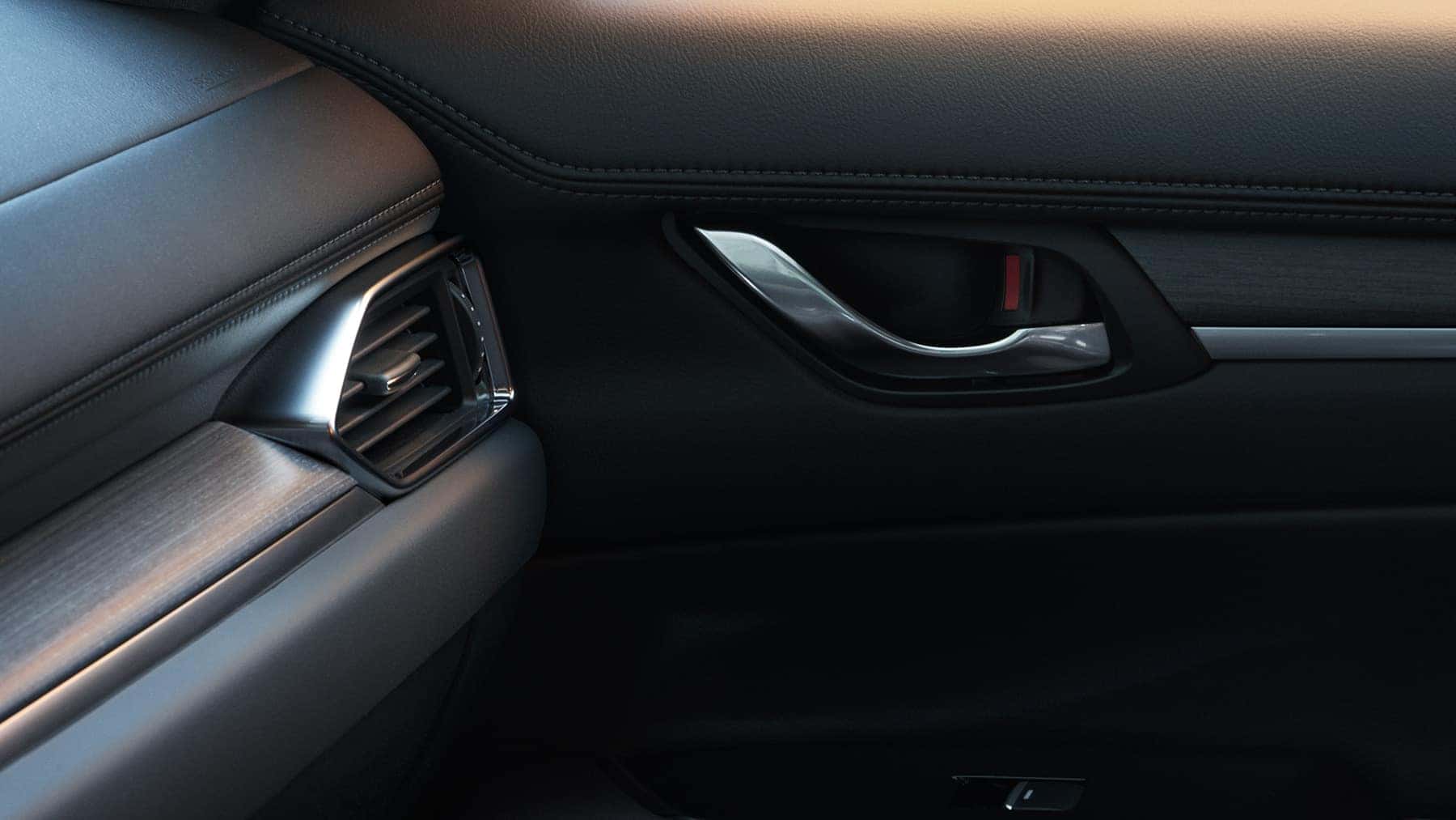 Premium interior of 2022 Mazda CX-5 Compact Crossover SUV. A/C vent and interior door handle