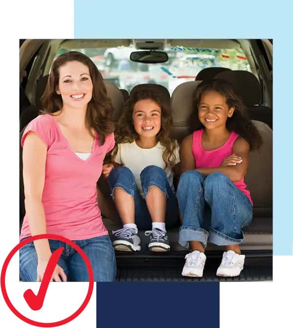 We're driving possibility. Image of mother in pink blouse and jeans and two daughters smiling at cam…