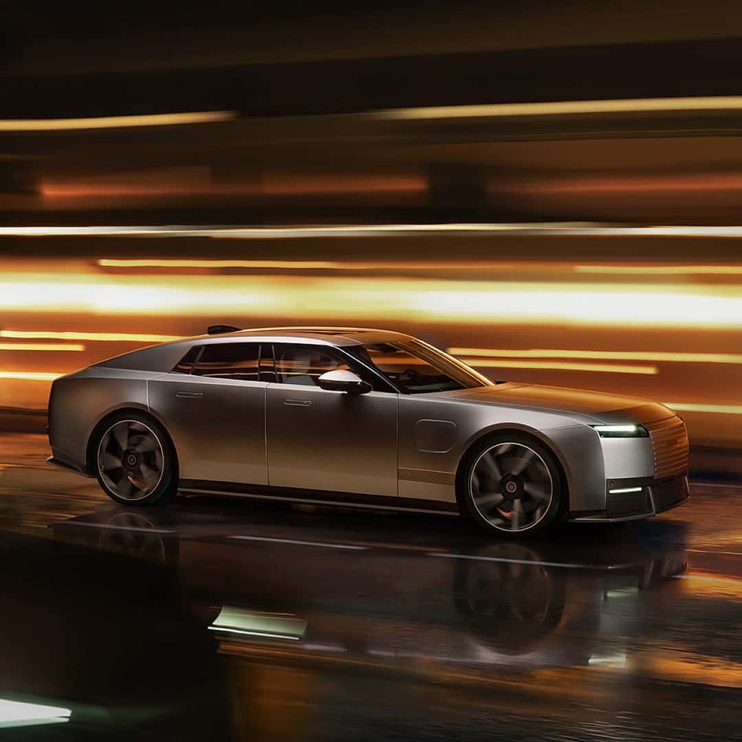 Jaguar Type 01 driving through a tunnel of amber light