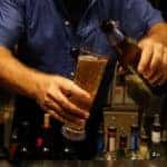 man pouring beer