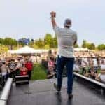 Jeff Belzer on stage facing crowd at Lakefront Music Fest